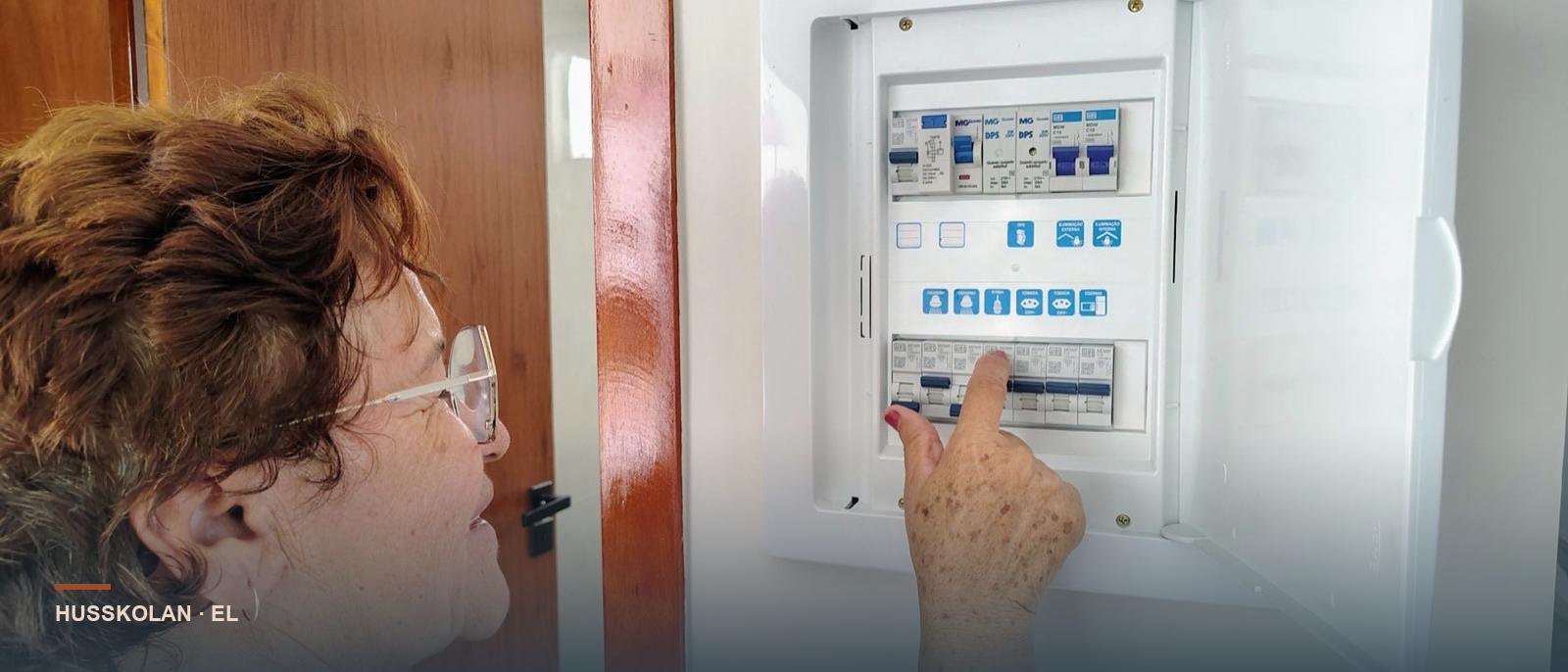 Husägare kontrollerar automatsäkringarna i sin elcentral